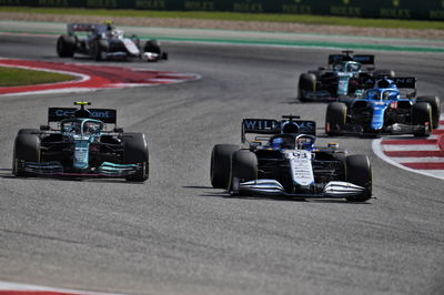 George Russell (GBR) Williams Racing FW43B and Sebastian Vettel (GER) Aston Martin F1 Team AMR21.