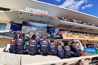 Red Bull Racing team watch the podium from the Longhorn car parked in parc ferme.