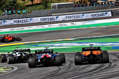 Esteban Ocon (FRA) Alpine F1 Team A521 and Daniel Ricciardo (AUS) McLaren MCL35M battle for position.