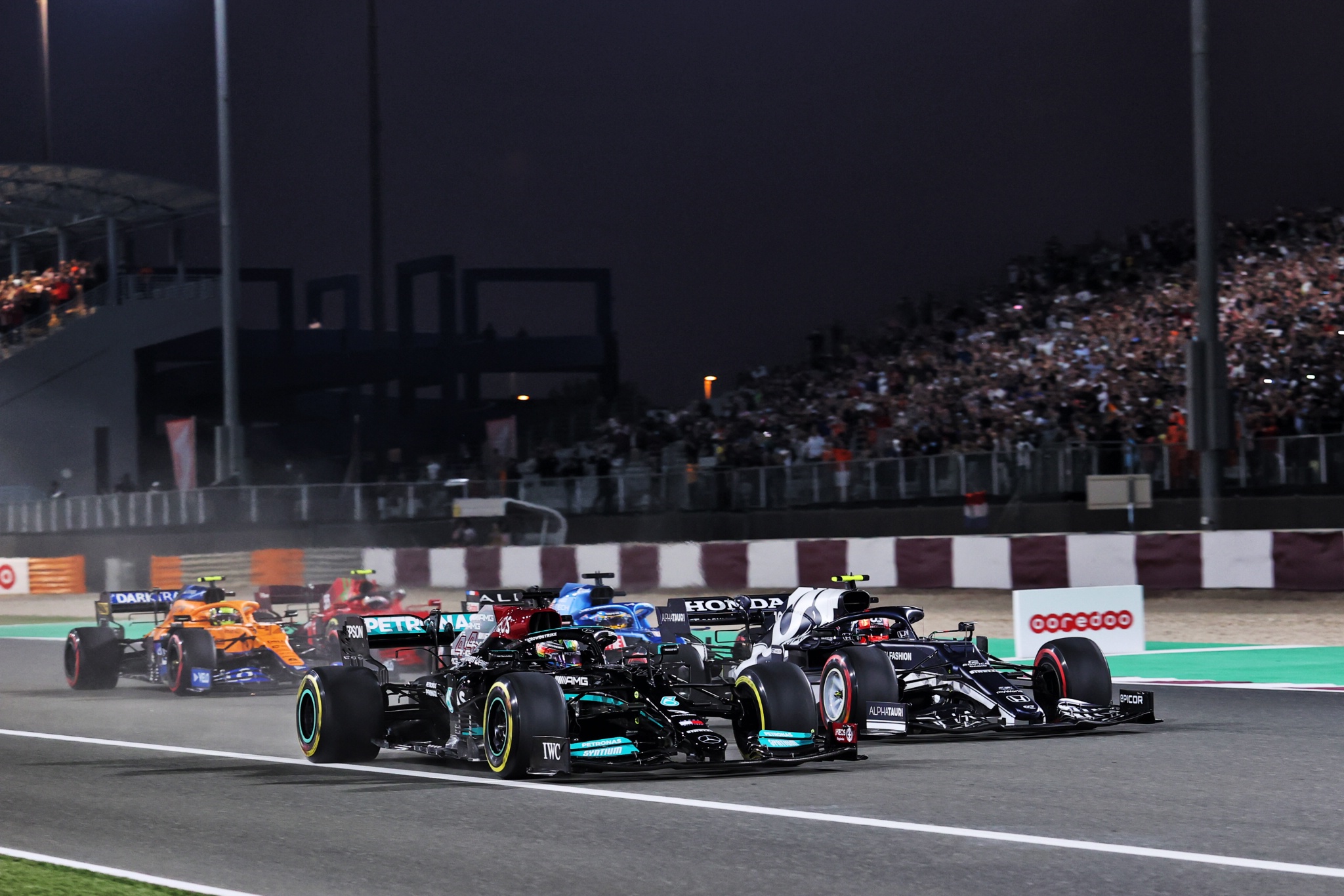 Lewis Hamilton (GBR) Mercedes AMG F1 W12 and Pierre Gasly (FRA) AlphaTauri AT02 battle for the lead at the start of the race.