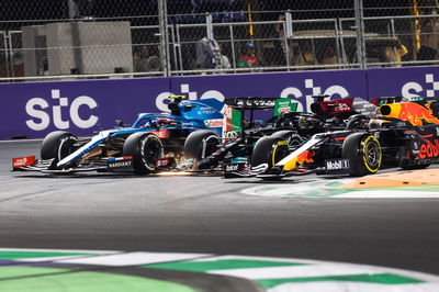 Esteban Ocon (FRA) Alpine F1 Team A521; Lewis Hamilton (GBR) Mercedes AMG F1 W12; and Max Verstappen (NLD) Red Bull Racing RB16B battle for the lead at the second race restart.