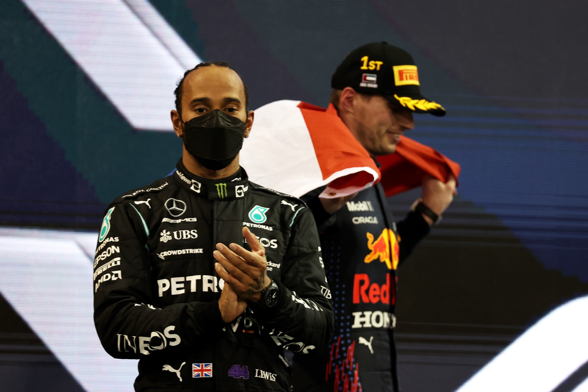 Lewis Hamilton (GBR) Mercedes AMG F1 W12 with 1st place and new World Champion, Max Verstappen (NLD) Red Bull Racing RB16B.