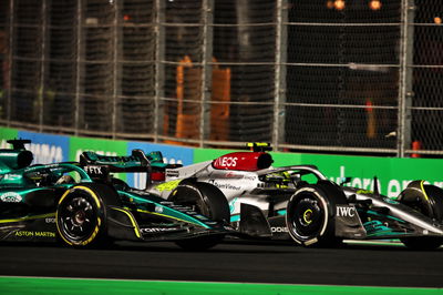 Lance Stroll (CDN) Aston Martin F1 Team AMR22 and Lewis Hamilton (GBR) Mercedes AMG F1 W13 battle for position.