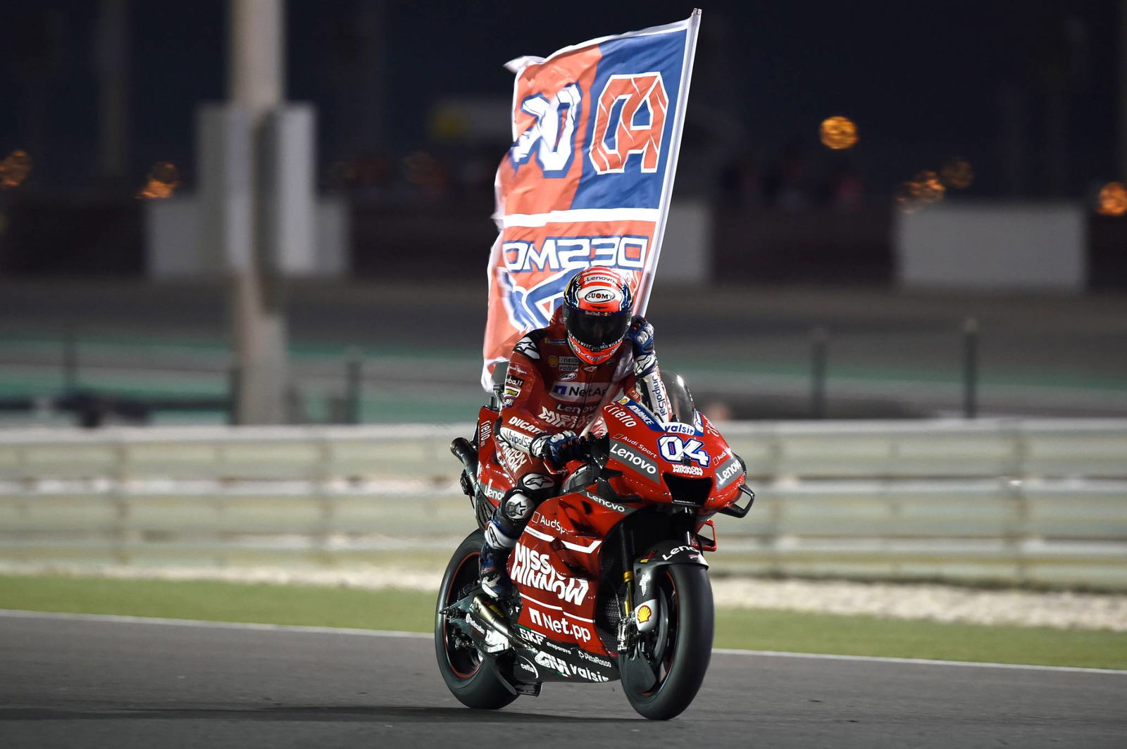 Rins yang berada di depan menuju panggung podium MotoGP pertama