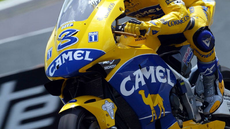 Biaggi takes win after Rossi penalised.