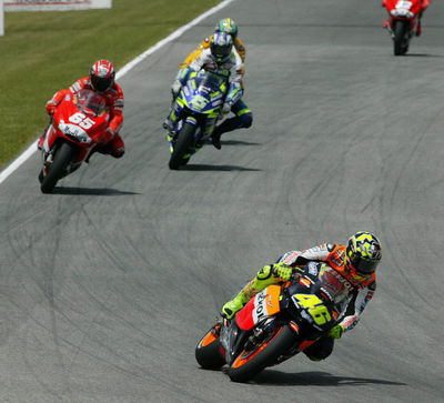 Rossi wins by millimetres after titanic battle.