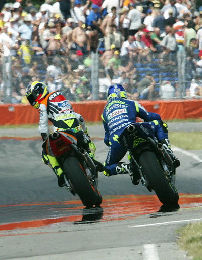 Gibernau defeats Rossi in photo finish.