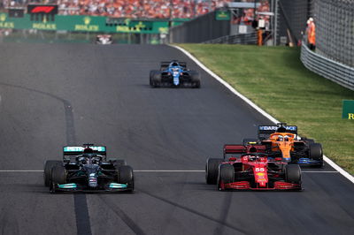 Carlos Sainz Jr (ESP) Ferrari SF-21 and Lewis Hamilton (GBR) Mercedes AMG F1 W12 battle for