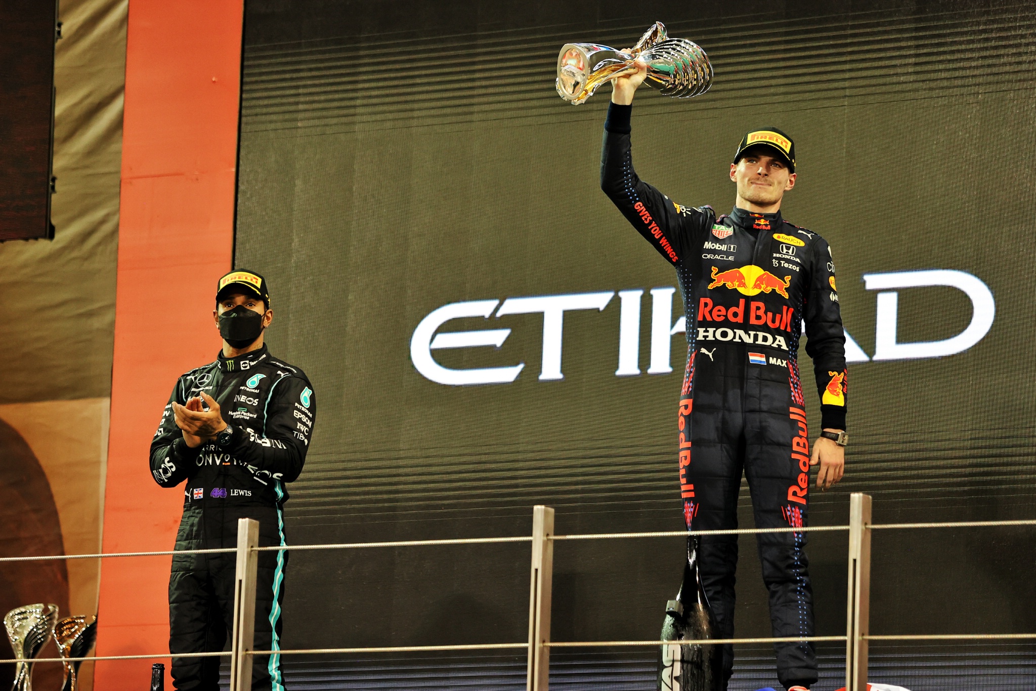 Race winner and World Champion Max Verstappen (NLD) Red Bull Racing celebrates on the podium alongside second placed Lewis