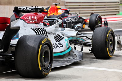 George Russell (GBR) Mercedes AMG F1 W13 and Max Verstappen (NLD) Red Bull Racing