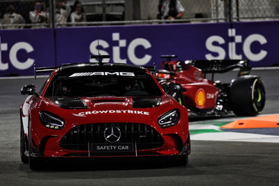 Charles Leclerc (MON) Ferrari F1-75 leads behind the Mercedes FIA Safety