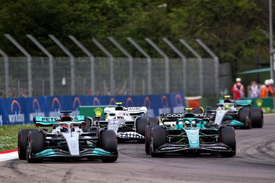 George Russell (GBR) Mercedes AMG F1 W13 and Sebastian Vettel (GER) Aston Martin F1 Team AMR22 battle for position.