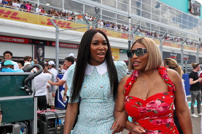 (L to R): Venus Williams (USA) Tennis player and sister Serena Williams (USA) Tennis Player on the grid. Formula 1 World