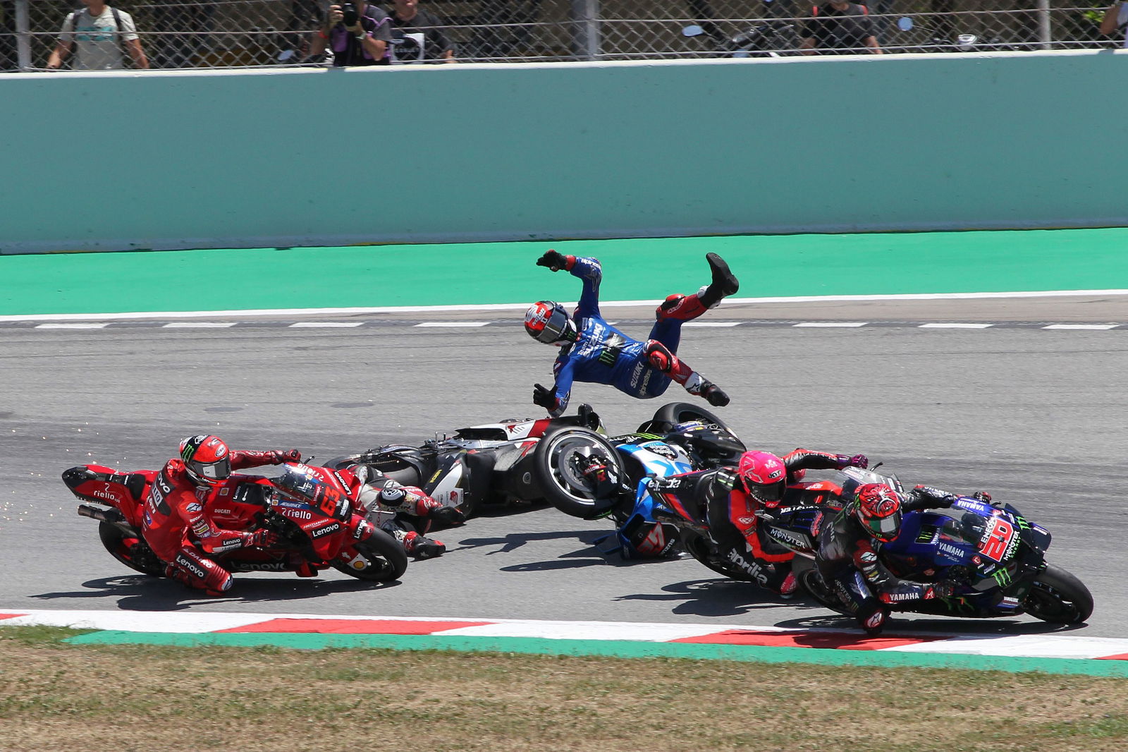  Takaaki Nakagami and Alex Rins crash, Francesco Bagnaia behind, Catalunya MotoGP. 5 July