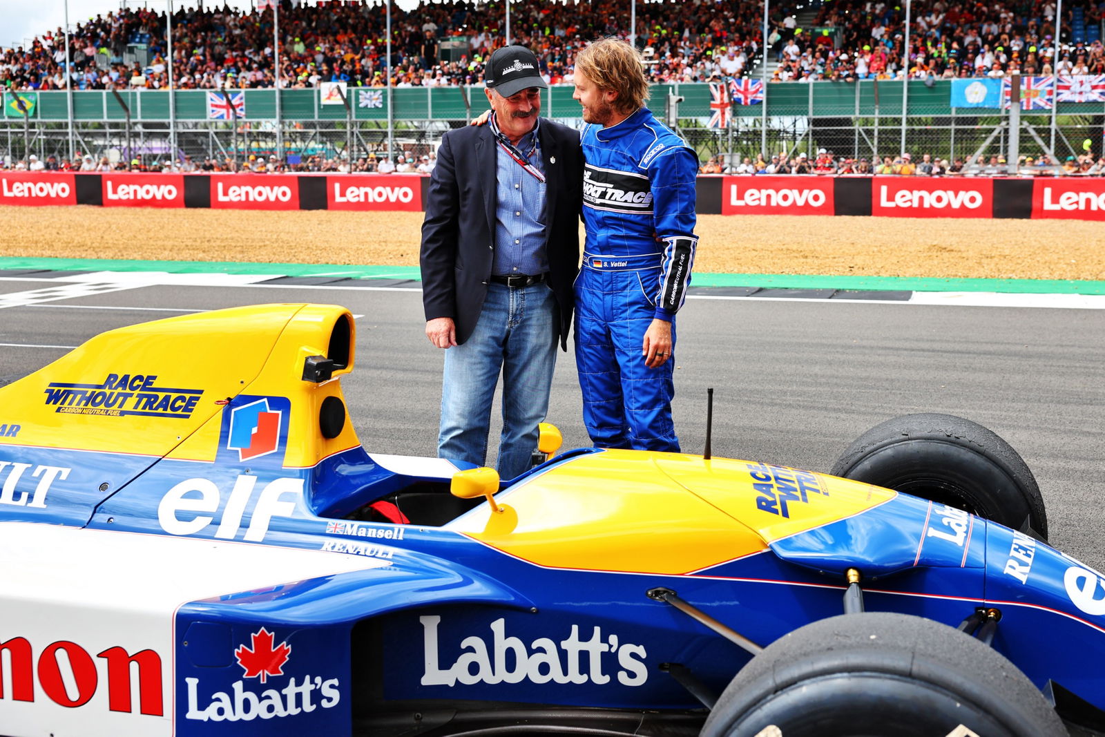 Sebastian Vettel (GER) Aston Martin F1 Team (Right) with Nigel Mansell (GBR) after he ran his Williams FW14B. Formula 1