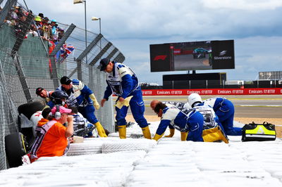 Guanyu Zhou (CHN) is extracted from his Alfa Romeo F1 Team C42 after he crashed at the start of the race. Formula 1 World