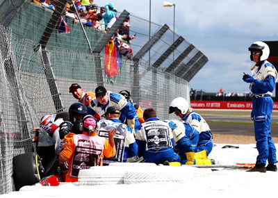 Guanyu Zhou (CHN) is extracted from his Alfa Romeo F1 Team C42 after he crashed at the start of the race. Formula 1 World