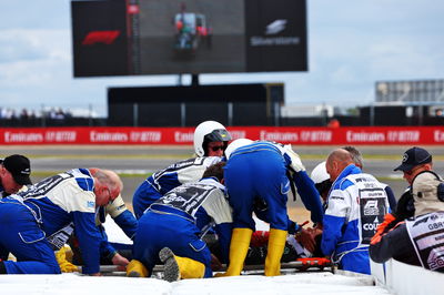 Guanyu Zhou (CHN) Alfa Romeo F1 Team is taken away on a stretcher into an ambulance after he crashed at the start of the