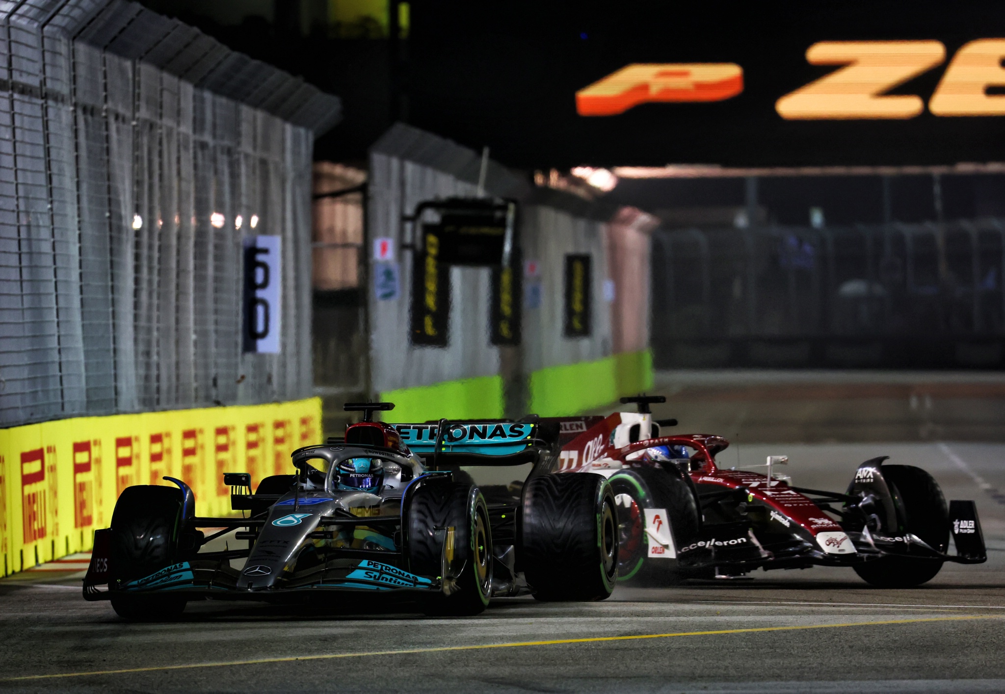 (L to R): George Russell (GBR) Mercedes AMG F1 W13 and Valtteri Bottas (FIN) Alfa Romeo F1 Team C42 battle for position.