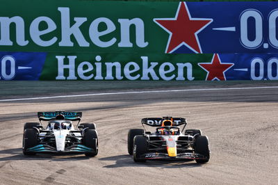 Max Verstappen (NLD) Red Bull Racing RB18 and George Russell (GBR) Mercedes AMG F1 W13 battle for the lead of the race.