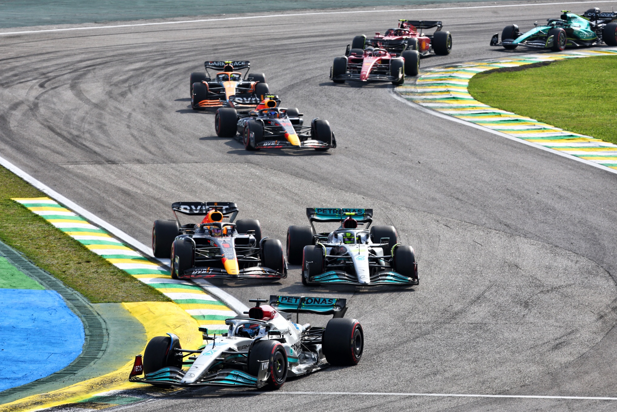 George Russell (GBR) Mercedes AMG F1 W13 leads as Max Verstappen (NLD) Red Bull Racing RB18 and Lewis Hamilton (GBR)