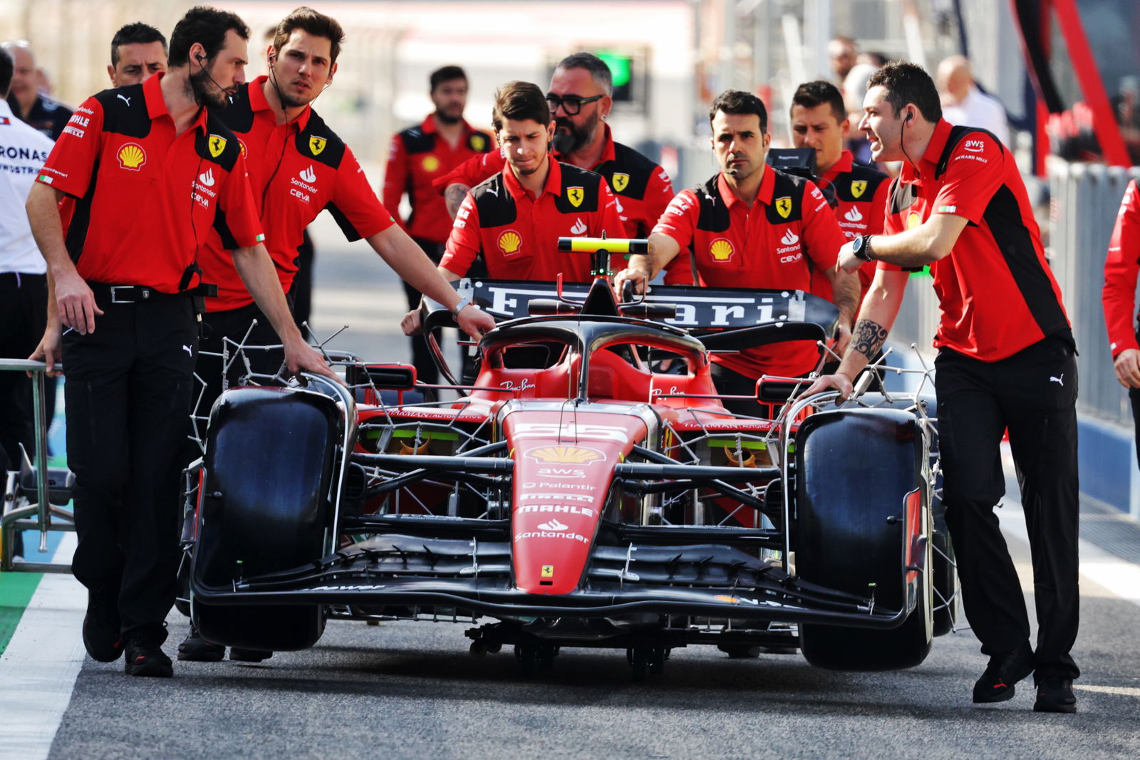 Ferrari SF-23 pushed down the pit lane by mechanics. Formula 1 Testing, Sakhir, Bahrain, Day One.- www.xpbimages.com,