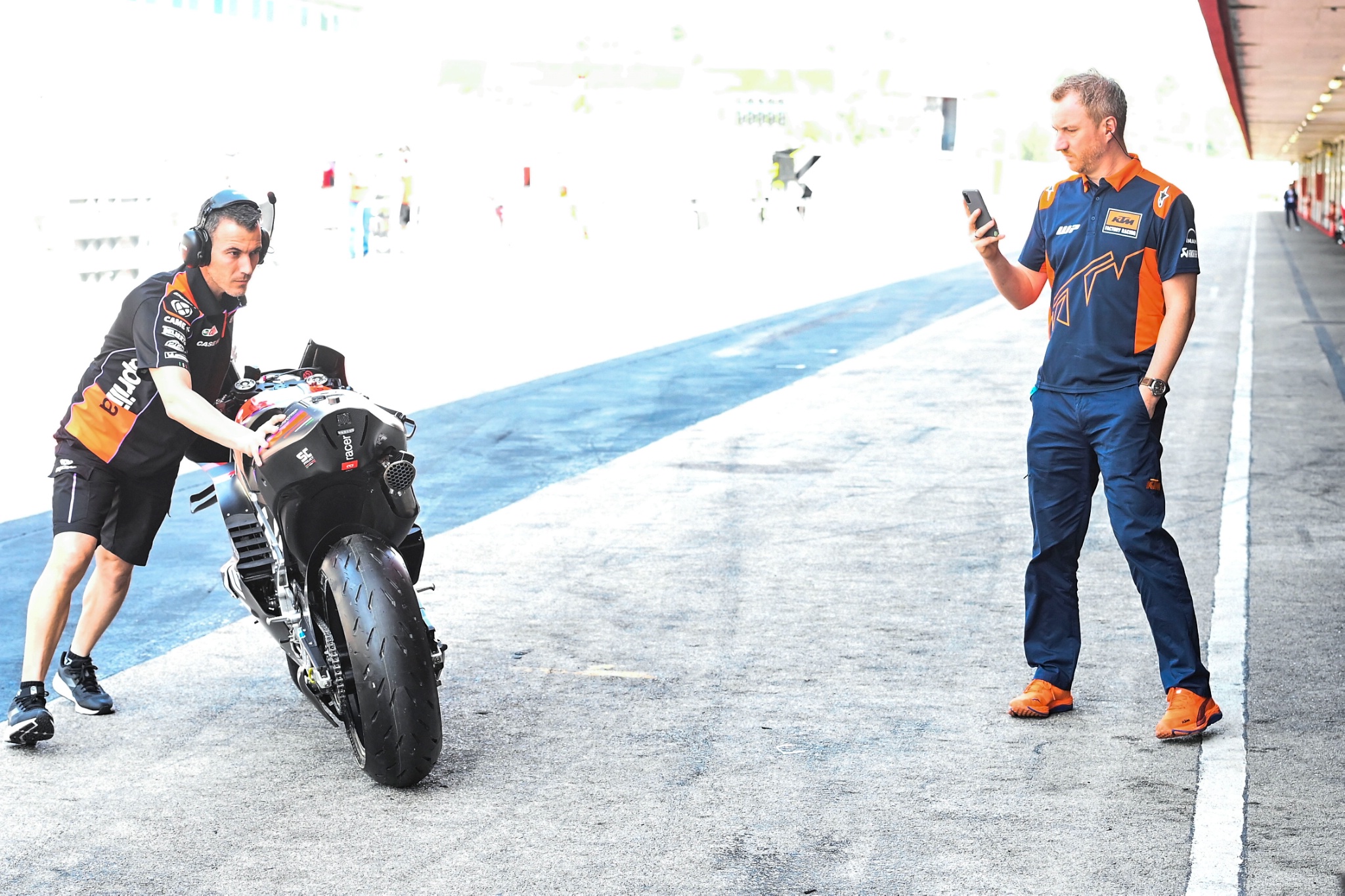 KTM technician photographing the Aprilia bike, Portimao MotoGP test, 12 March