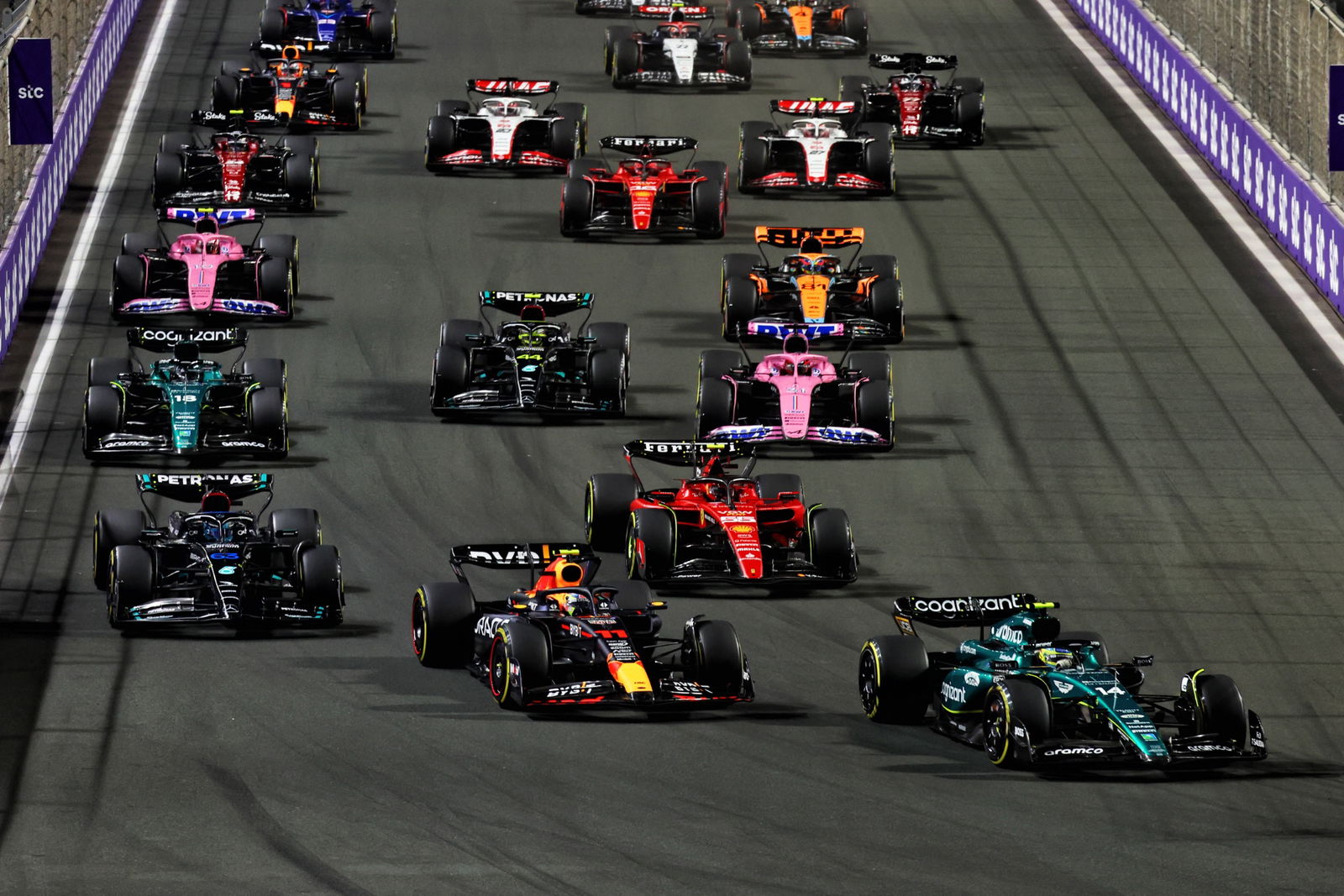 Fernando Alonso (ESP) Aston Martin F1 Team AMR23 leads Sergio Perez (MEX) Red Bull Racing RB19 at the start of the race.
