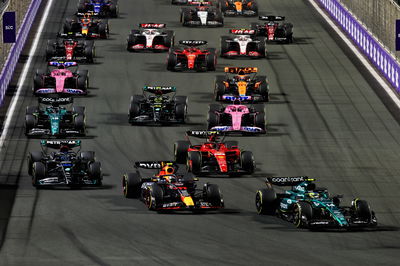 Fernando Alonso (ESP) Aston Martin F1 Team AMR23 leads Sergio Perez (MEX) Red Bull Racing RB19 at the start of the race.
