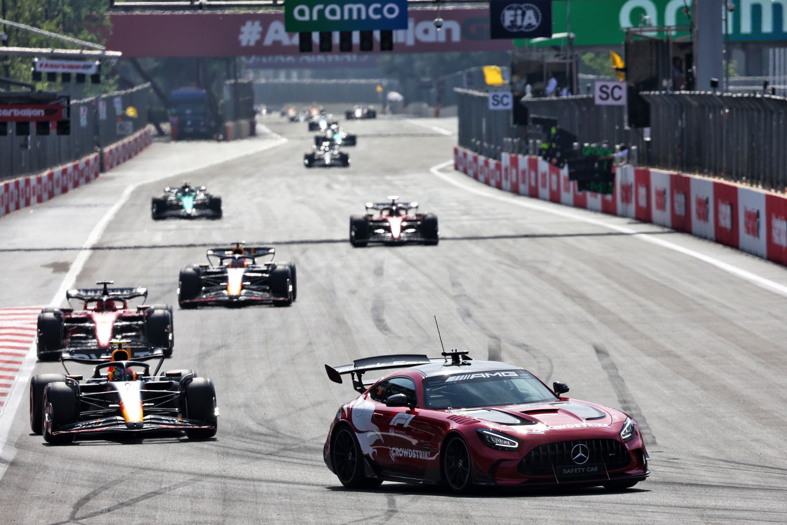 Sergio Perez (MEX) Red Bull Racing RB19 leads behind the Mercedes FIA Safety Car. Formula 1 World Championship, Rd 4,