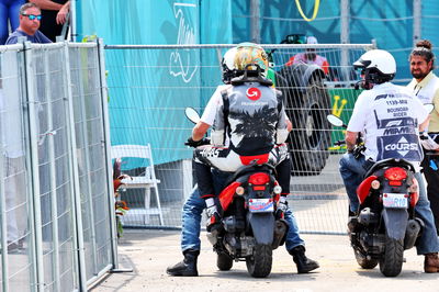 Nico Hulkenberg (GER ) Haas F1 Team kembali ke pit dengan menunggangi skuter setelah menabrak pada latihan pertama