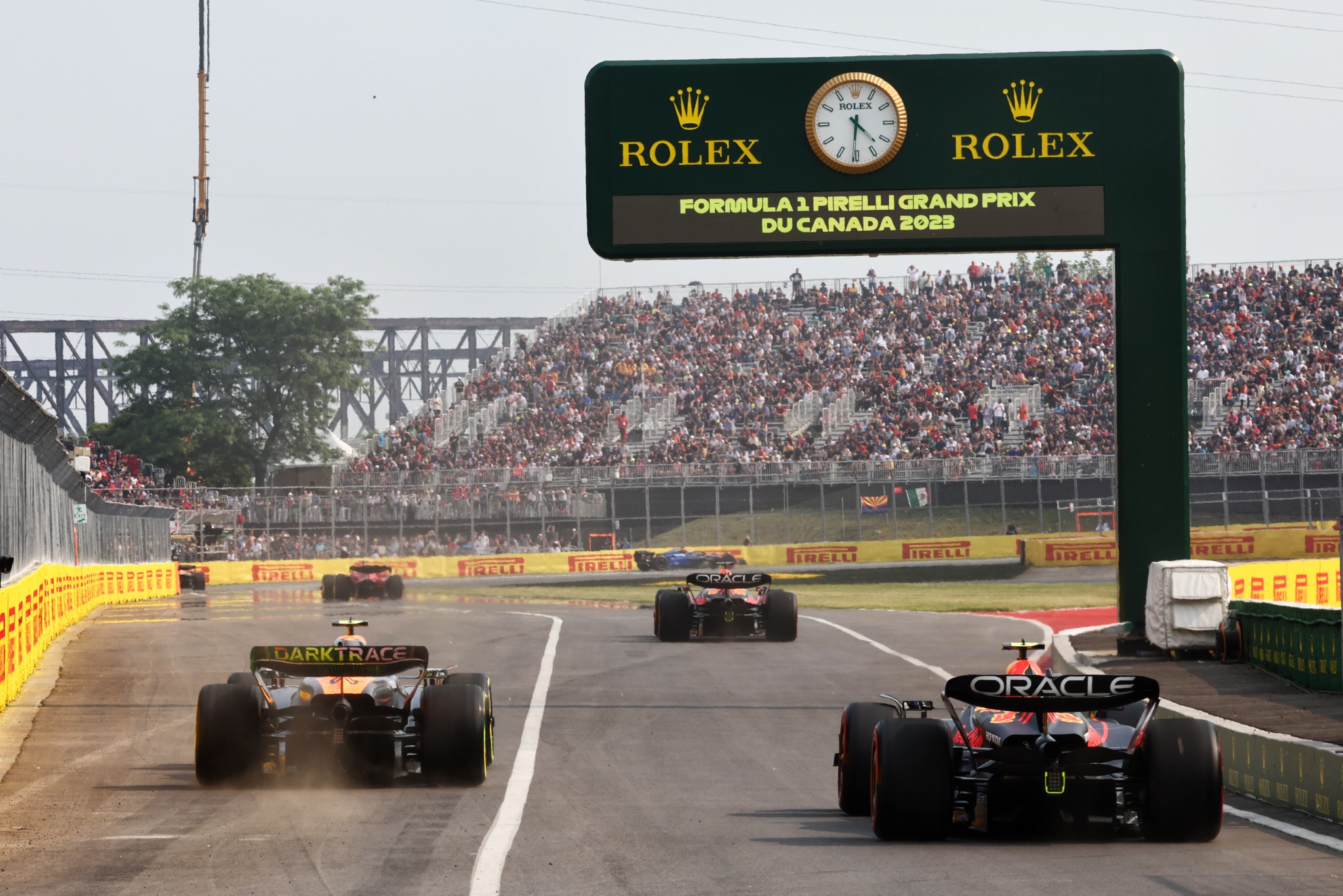 Sergio Perez (MEX) Red Bull Racing RB19 and Lando Norris (GBR) McLaren MCL60 leave the pits. Formula 1 World Championship,