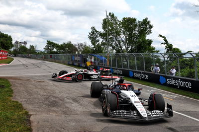 Nyck de Vries (NLD) AlphaTauri AT04 and Kevin Magnussen (DEN) Haas VF-23 run on at the exit road and reverse back on to the