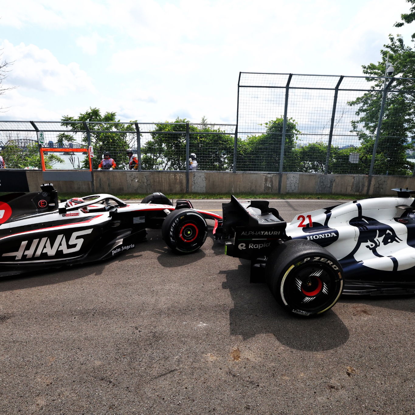 Nyck de Vries (NLD) AlphaTauri AT04 and Kevin Magnussen (DEN) Haas VF-23 run on at the exit road and reverse back on to the