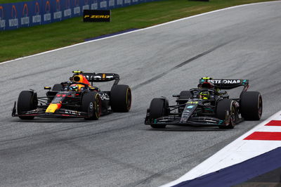 (L to R): Sergio Perez (MEX) Red Bull Racing RB19 and Lewis Hamilton (GBR) Mercedes AMG F1 W14 battle for position.