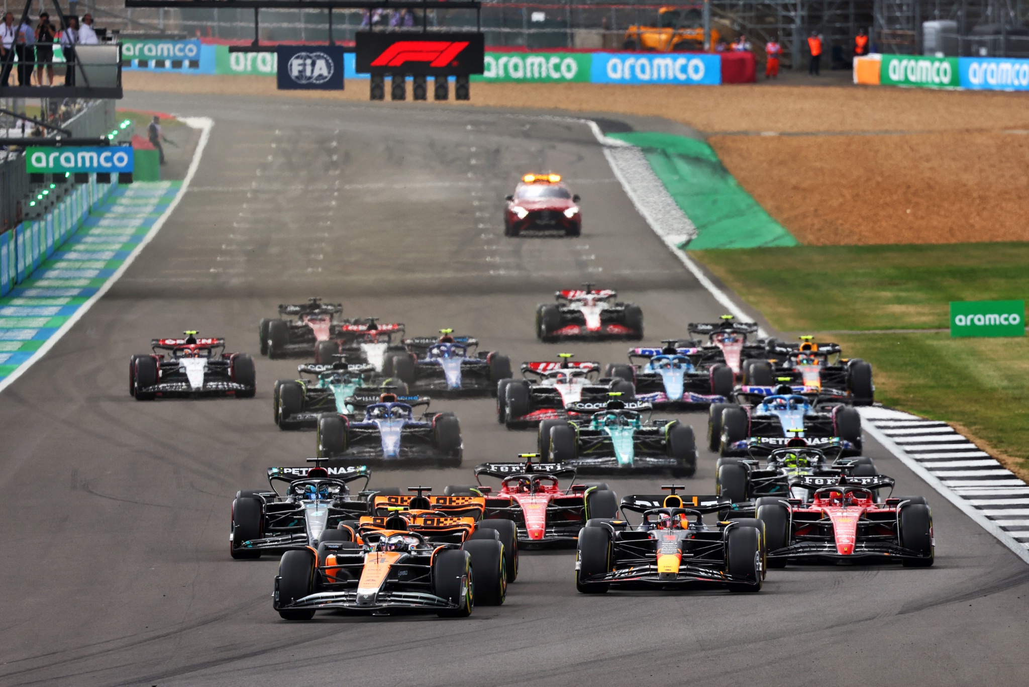 Lando Norris (GBR) McLaren MCL60 leads Max Verstappen (NLD) Red Bull Racing RB19 and Oscar Piastri (AUS) McLaren MCL60 at