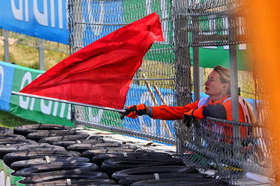 A marshal waves a red flag in the first practice session. Formula 1 World Championship, Rd 14, Dutch Grand Prix,