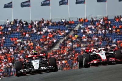 Yuki Tsunoda (JPN) AlphaTauri AT04 and Kevin Magnussen (DEN) Haas VF-23. Formula 1 World Championship, Rd 14, Dutch Grand