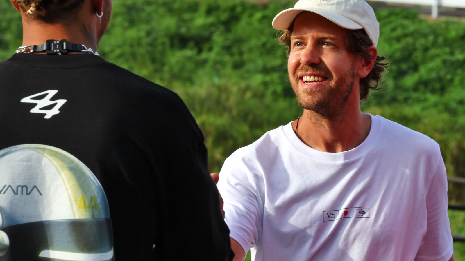 (L to R): Lewis Hamilton (GBR) Mercedes AMG F1 with Sebastian Vettel (GER) - Bee Hotel at Buzzin' Corner. Formula 1 World