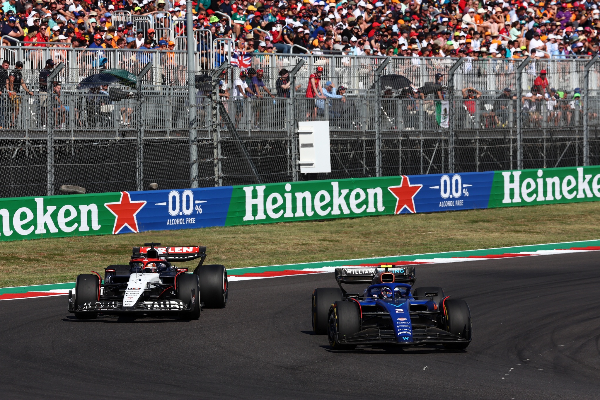 Daniel Ricciardo (AUS) AlphaTauri AT04 and Logan Sargeant (USA) Williams Racing FW45 battle for position. Formula 1 World