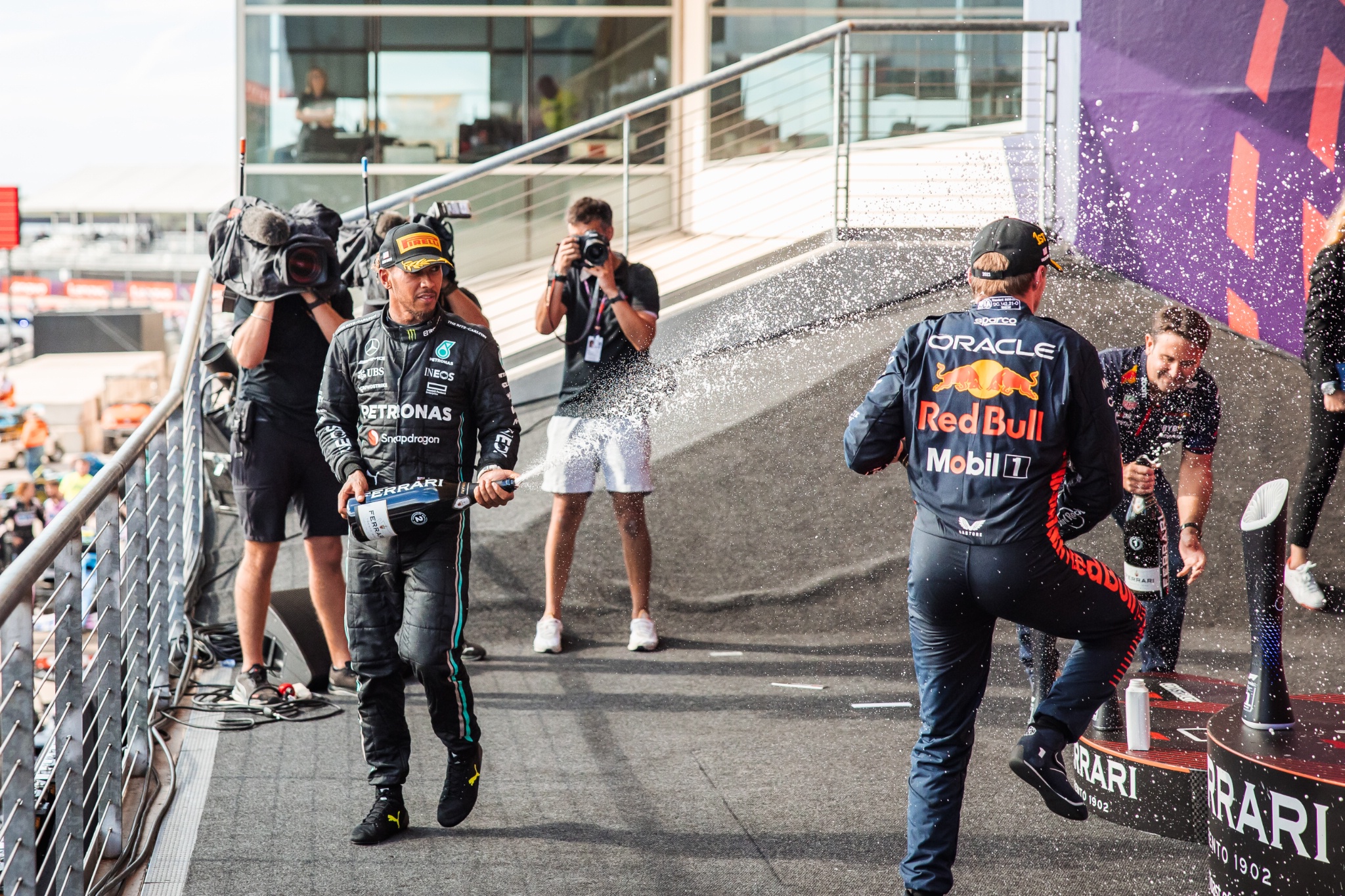 Lewis Hamilton (GBR) Mercedes AMG F1 celebrates his second position on the podium with Max Verstappen (NLD) Red Bull