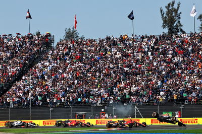 Sergio Perez (MEX) Red Bull Racing RB19 is launched into the air after contact with Charles Leclerc (MON) Ferrari SF-23 at