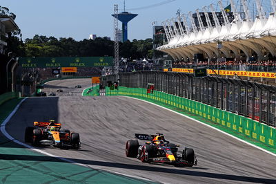 Max Verstappen (NLD) Red Bull Racing RB19 leads Lando Norris (GBR) McLaren MCL60. Formula 1 World Championship, Rd 21,