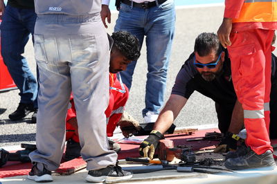 Circuit workers repair a damaged drain cover at turn 11. Formula 1 Testing, Sakhir, Bahrain, Day Two.-