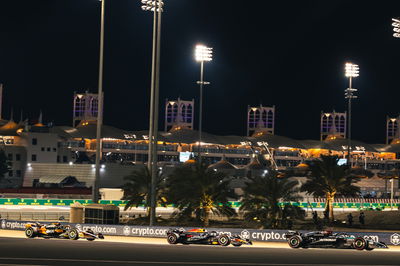 George Russell (GBR) Mercedes AMG F1 W15 leads Max Verstappen (NLD) Red Bull Racing RB20 and Lando Norris (GBR) McLaren