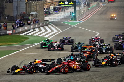 Max Verstappen (NLD) Red Bull Racing RB20 leads Charles Leclerc (MON) Ferrari SF-24 at the start of the race. Formula 1