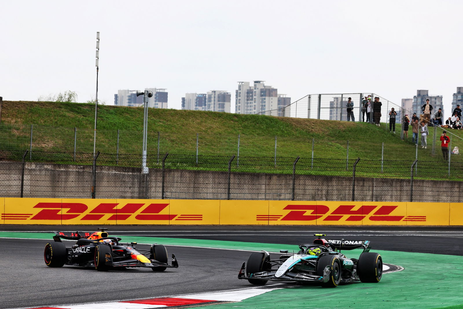 Lewis Hamilton (GBR) Mercedes AMG F1 W15 runs wide ahead of Max Verstappen (NLD) Red Bull Racing RB20. Formula 1 World