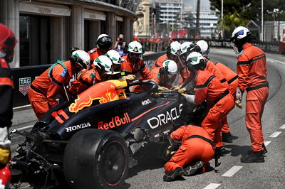 The Red Bull Racing RB20 of Sergio Perez (MEX) Red Bull Racing removed by marshals after the race stopping start crash.