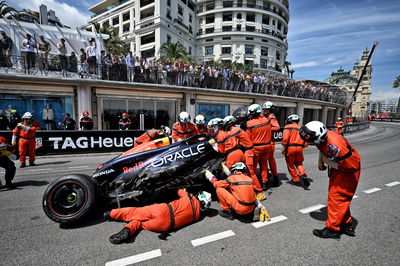 The Red Bull Racing RB20 of Sergio Perez (MEX) Red Bull Racing removed by marshals after the race stopping start crash.