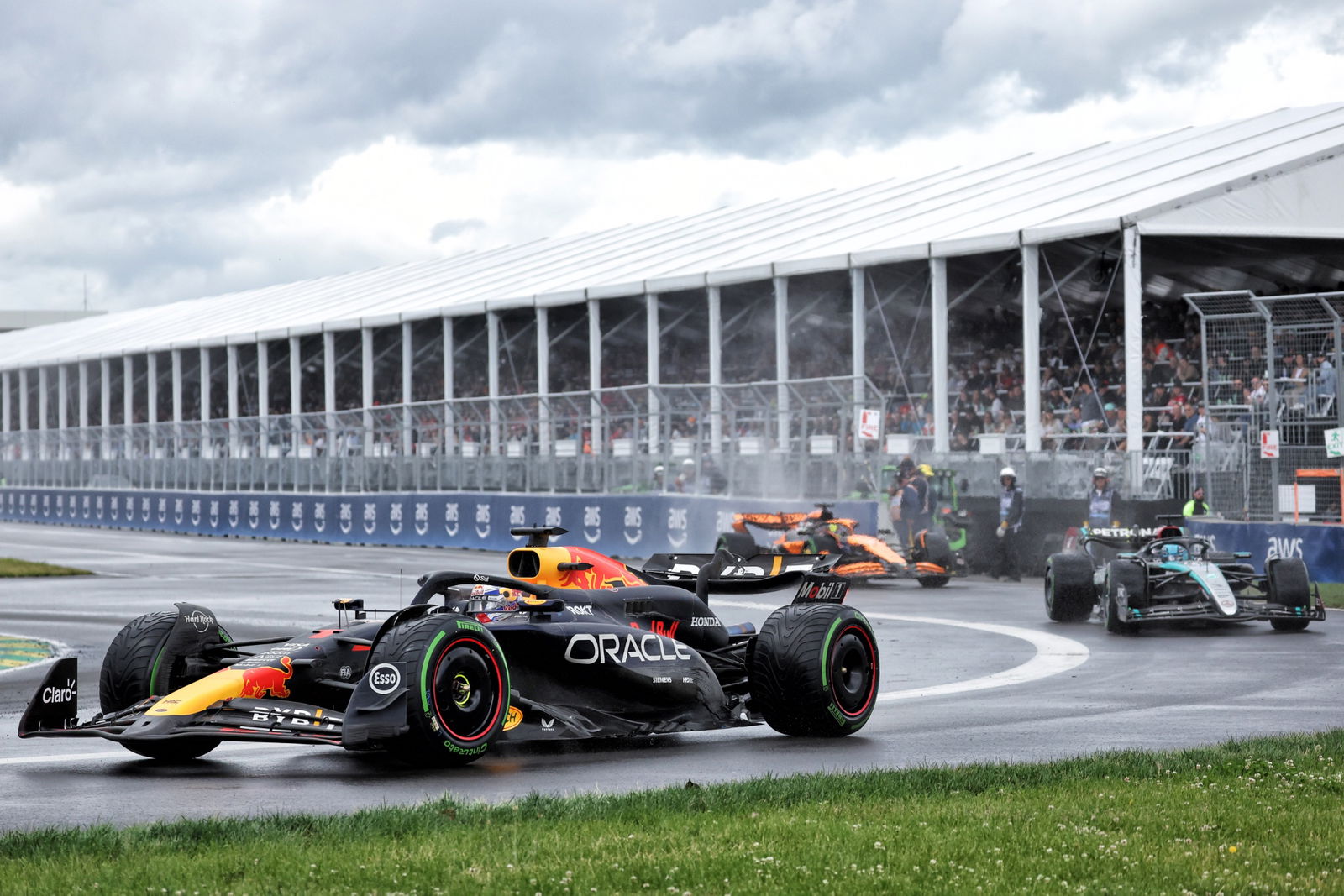 Max Verstappen (NLD) Red Bull Racing RB20 leaves the pits ahead of George Russell (GBR) Mercedes AMG F1 W15 and Oscar